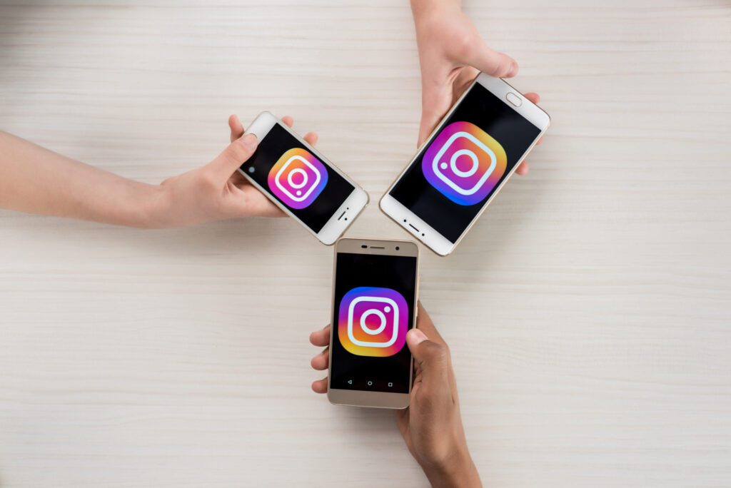 three smartphones opening instagram